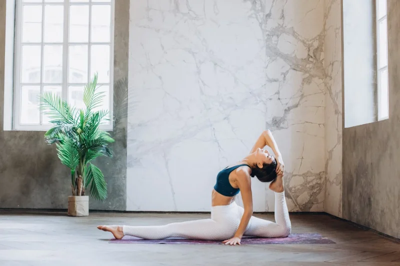 A figure in a yoga pose, focusing on the connection between mind and body through the practice of asanas